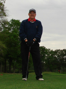 Photo of Logan, golf club in hand