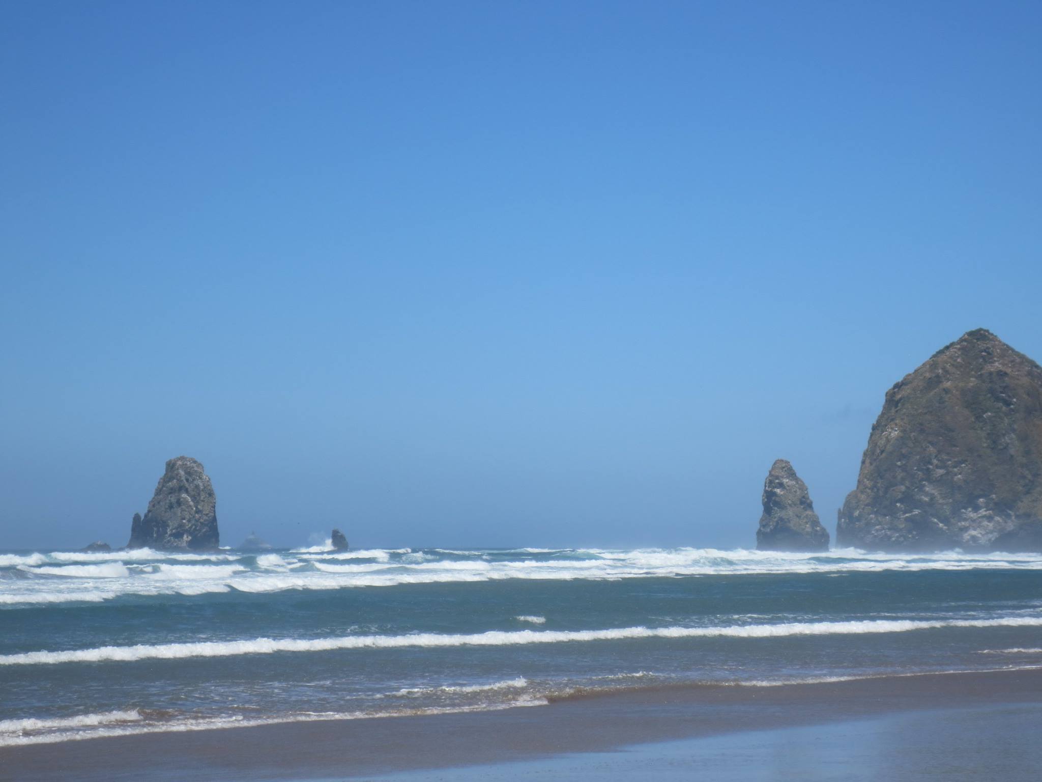 photo of the shoreline at Cannon Beach, featuring Haystack Rock